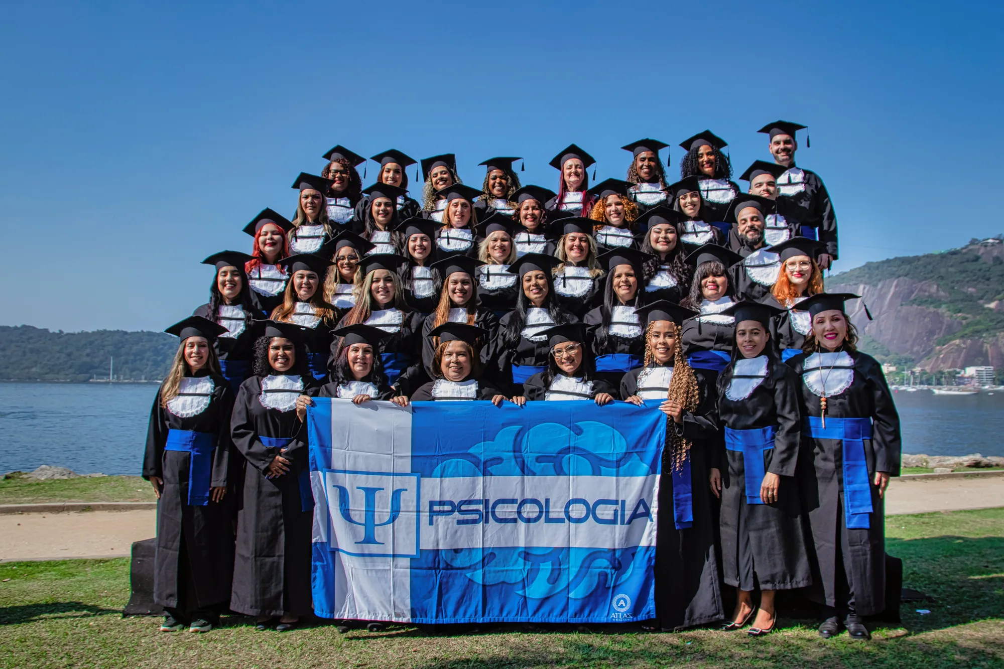 Turma de Psicologia reunida com a bandeira do curso no Aterro do Flamengo